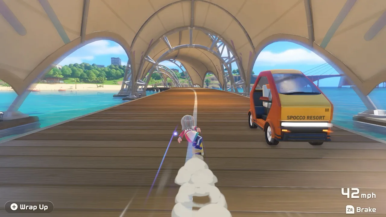 Skateboarding past a parked van under a seaside arch while exploring Wuhu Island
